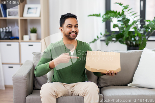 Image of indian man with box of takeaway pizza at home