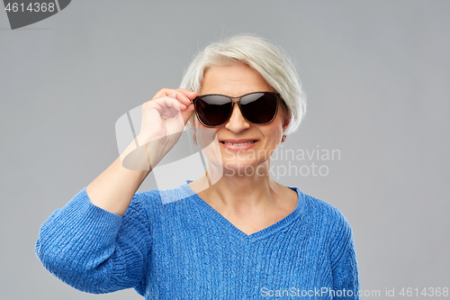 Image of smiling senior woman in black sunglasses