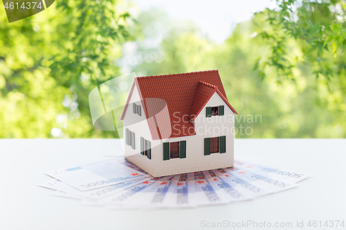 Image of close up of home or house model and money