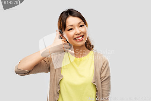Image of african asian making phone call gesture