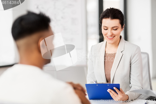 Image of employer having interview with employee at office