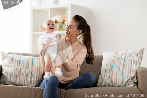 Image of happy mother with little baby boy at home