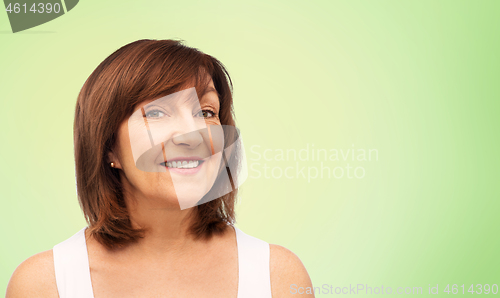 Image of portrait of smiling senior woman over lime green