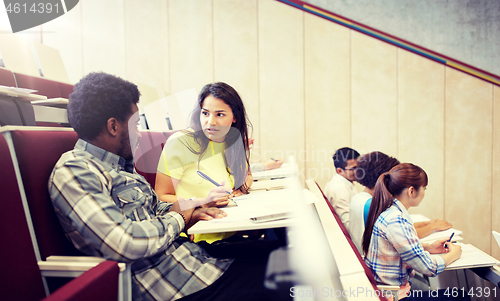 Image of group of students with notebooks at lecture hall