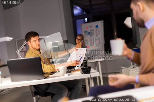 Image of designers or software developers at night office