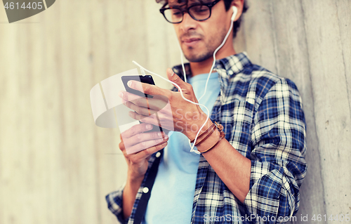 Image of man with earphones and smartphone listening music