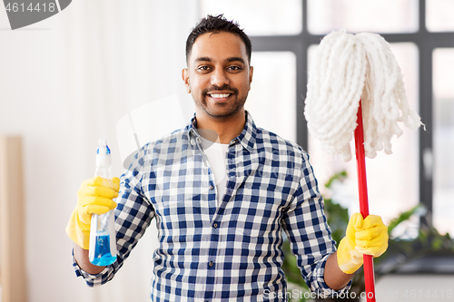 Image of indian man with mop and detergent cleaning at home