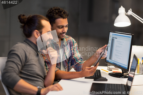 Image of creative team with tablet pc working at office