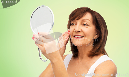 Image of portrait of smiling senior woman with mirror