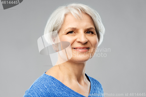 Image of portrait of smiling senior woman in blue sweater