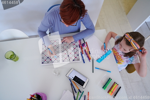 Image of Mother and little daughter  playing together  drawing creative a