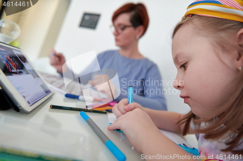 Image of Mother and little daughter  playing together  drawing creative a