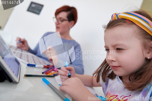 Image of Mother and little daughter  playing together  drawing creative a