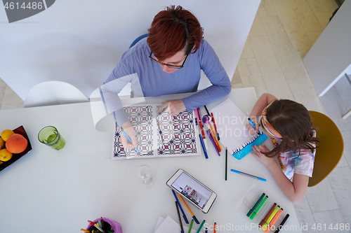 Image of Mother and little daughter  playing together  drawing creative a