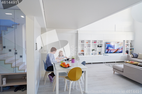 Image of Mother and little daughter  playing together  drawing creative a