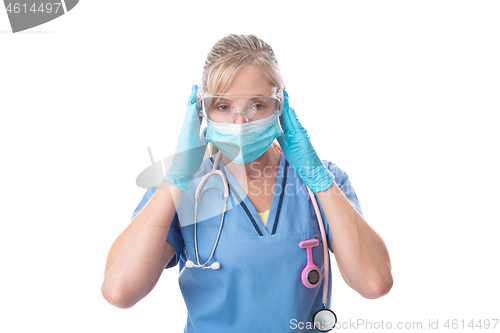 Image of Nurse putting on protective mask gloves and goggles