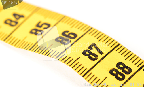 Image of Close-up of a yellow measuring tape isolated on white - 87