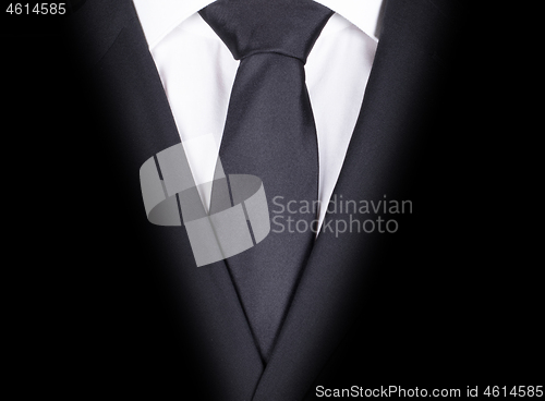 Image of Man in a black suit, close-up