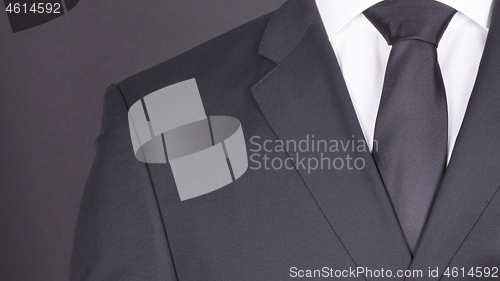 Image of Man in a black suit, close-up