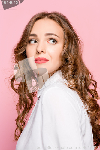 Image of Portrait of young woman arrogantly looking in camera isolated