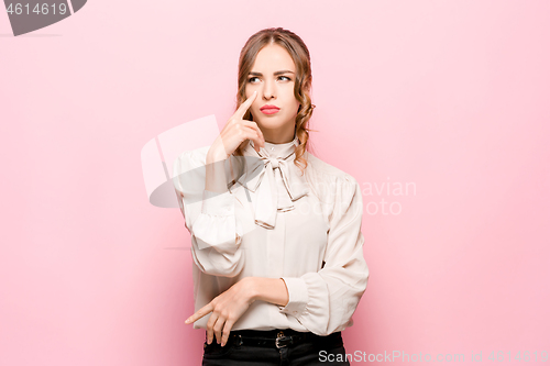 Image of Young serious thoughtful business woman. Doubt concept.