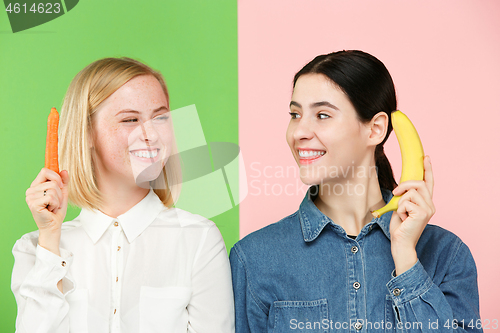 Image of Beautiful close-up portrait of young women with fruits and vegetables. Healthy food concept.