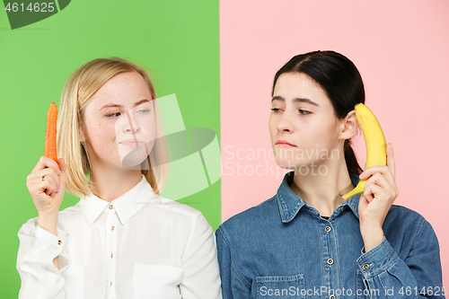 Image of Beautiful close-up portrait of young women with fruits and vegetables. Healthy food concept.