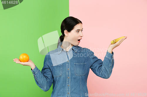 Image of Beautiful close-up portrait of young woman with fruits. Healthy food concept.