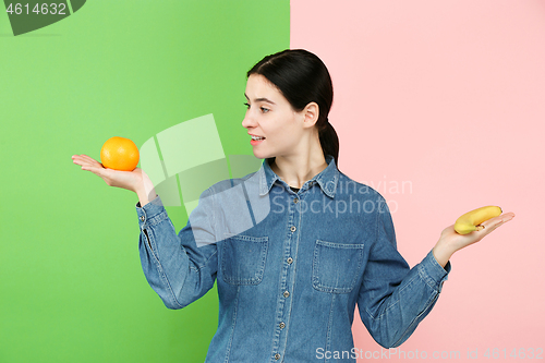 Image of Beautiful close-up portrait of young woman with fruits. Healthy food concept.