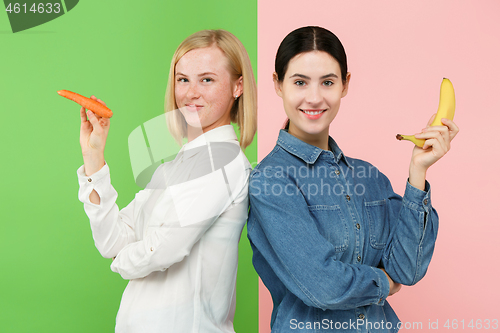 Image of Beautiful close-up portrait of young women with fruits and vegetables. Healthy food concept.