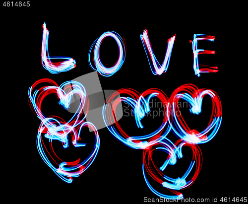 Image of Glowing inscription LOVE on a black background