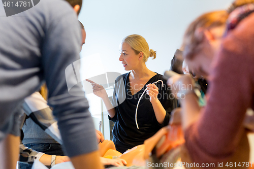 Image of Medical doctor specialist expert displaying method of patient intubation on hands on medical education training and workshop. Participants learning new medical procedures and techniques.