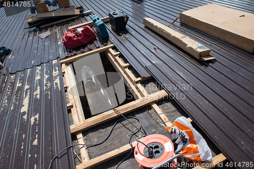 Image of Construction worker installing a new roof