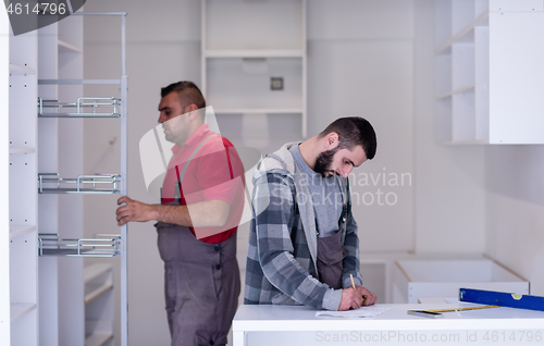 Image of workers installing a new kitchen