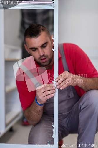 Image of worker installing a new kitchen