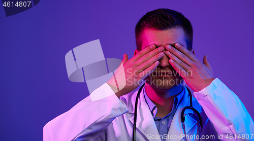 Image of coronavirus pandemic doctor covering eyes
