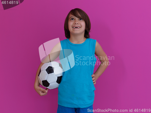 Image of Arabic boy with soccer ball against  pink background