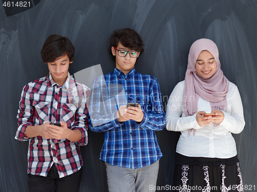 Image of arab teenagers group using smart phones for social media network