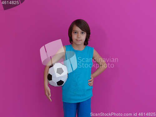 Image of Arabic boy with soccer ball against  pink background