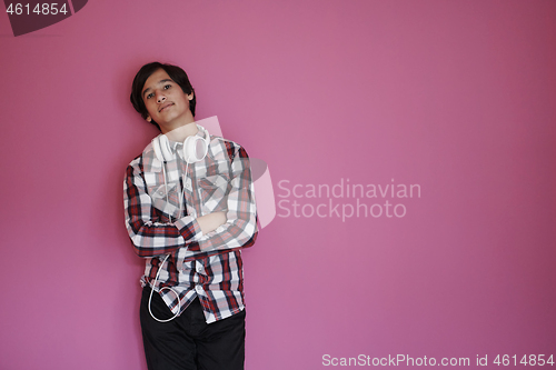 Image of portrait  of smart looking arab teenager  against pink backgroun