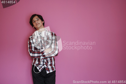 Image of portrait  of smart looking arab teenager  against pink backgroun