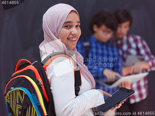 Image of Arab teenagers group working on laptop and tablet computer