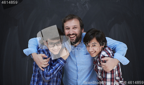 Image of happy father hugging sons