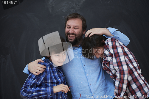 Image of happy father hugging sons