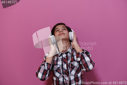 Image of Arab Teenage Boy Wearing Headphones And Listening To Music