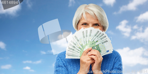 Image of senior woman with hundreds of euro money banknotes