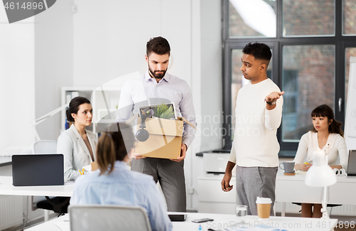 Image of fired sad male office worker leaving