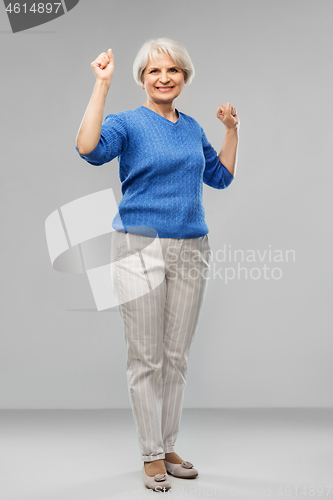 Image of portrait of happy senior woman celebrating success