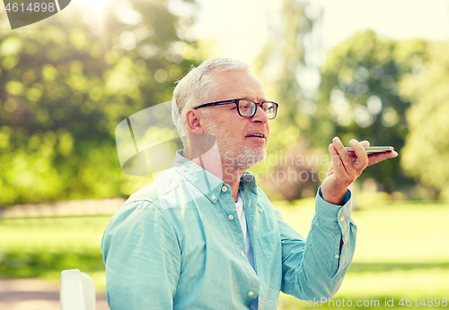 Image of old man using voice command recorder on smartphone