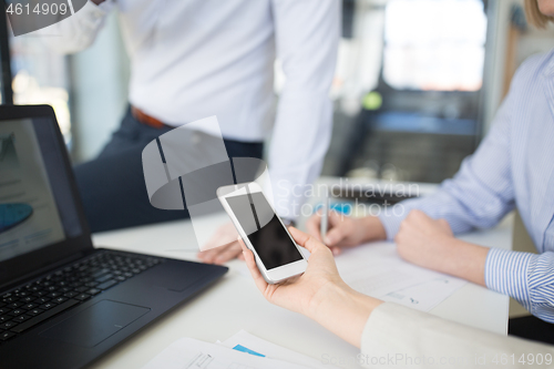 Image of business team with smartphone working at office